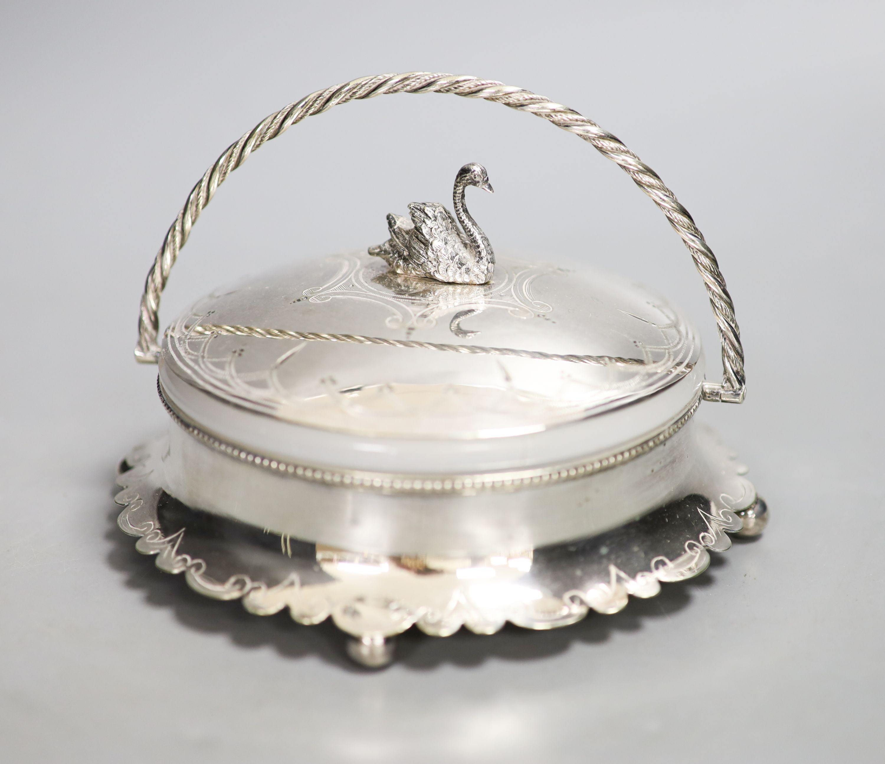 A silver plated powder box, the lid with swan finial.